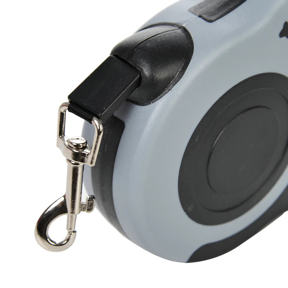 Close-up of a retractable dog leash with a metal clip on a white background