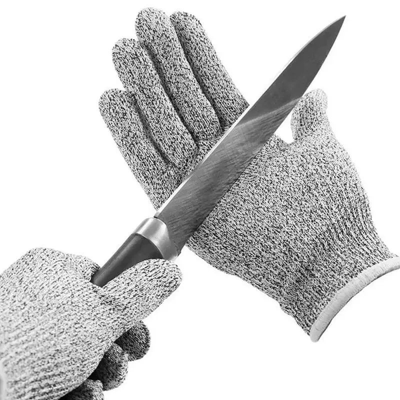 Pair of cut-resistant gloves holding a knife on a white background