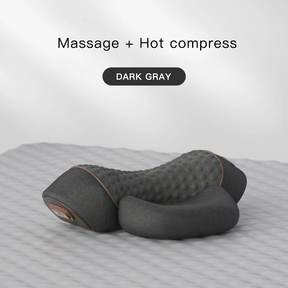 Dark gray massage and hot compress pillow on a textured surface with 'Massage + Hot compress' text above.