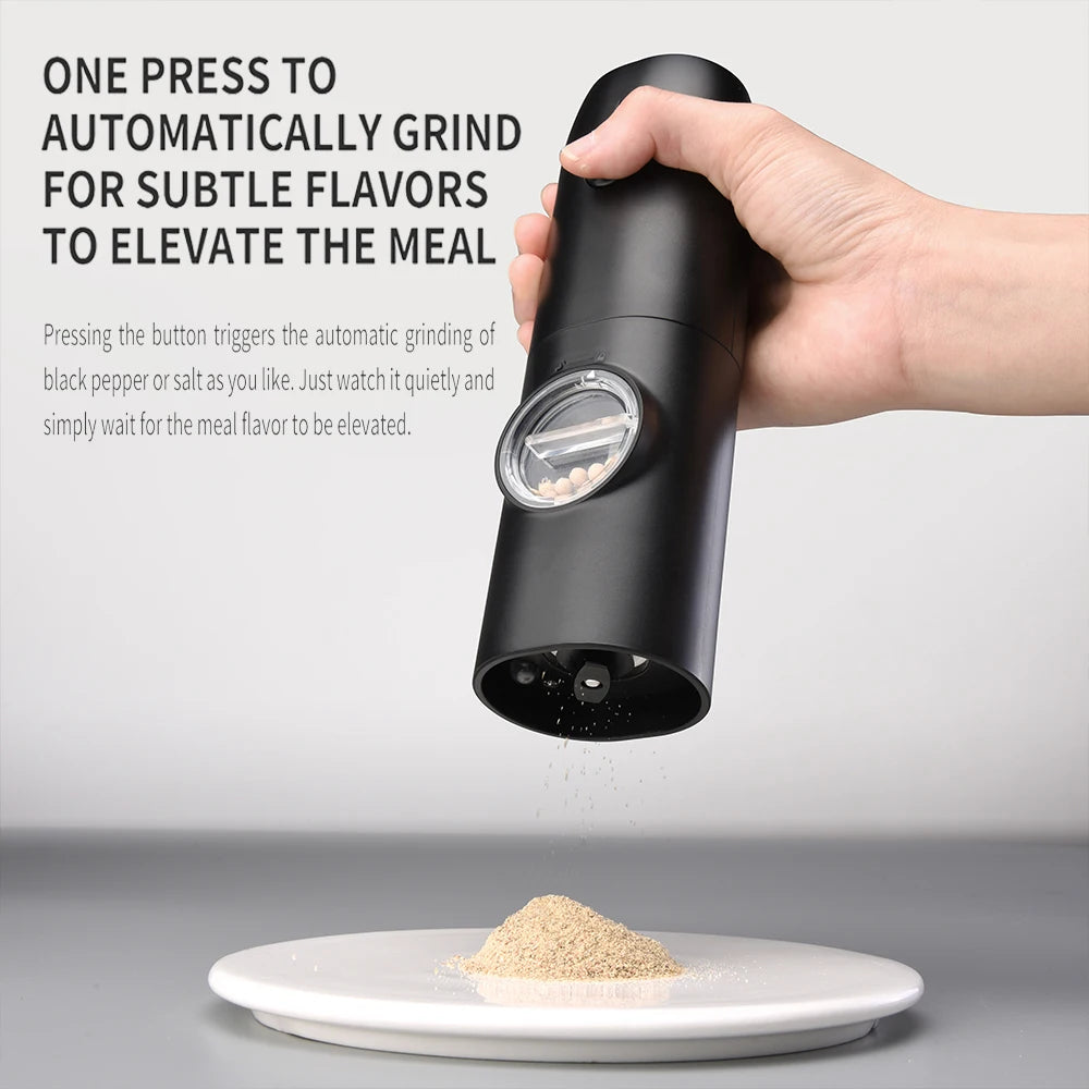 Black pepper grinder being held above a plate with ground pepper on a gray background