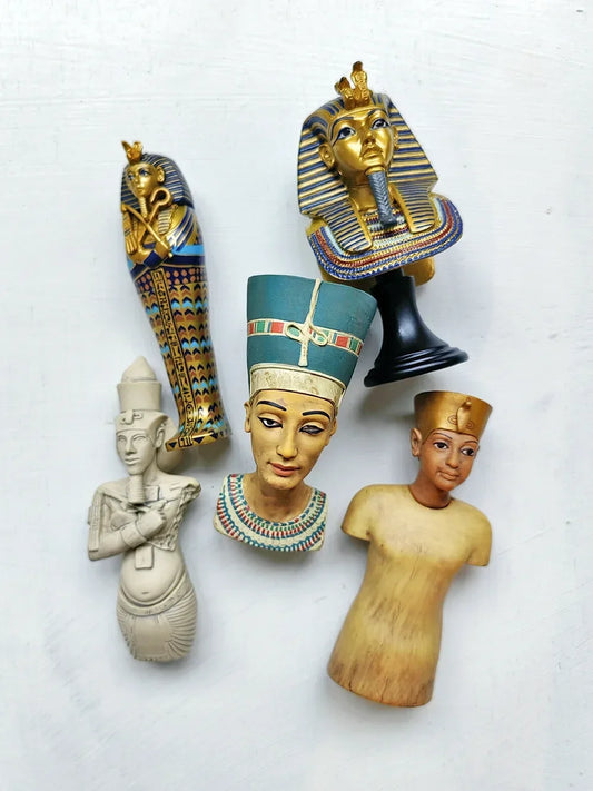Collection of Egyptian-themed figurines on a white background
