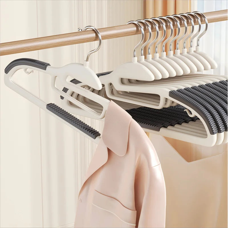 Set of multi-layer hangers with a coat on a wooden rod against a neutral background