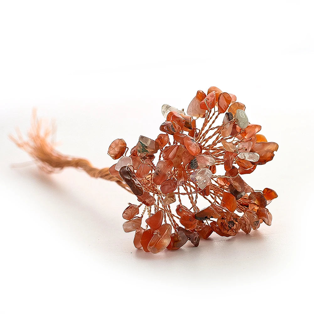Decorative branch with orange and brown stones on a white background