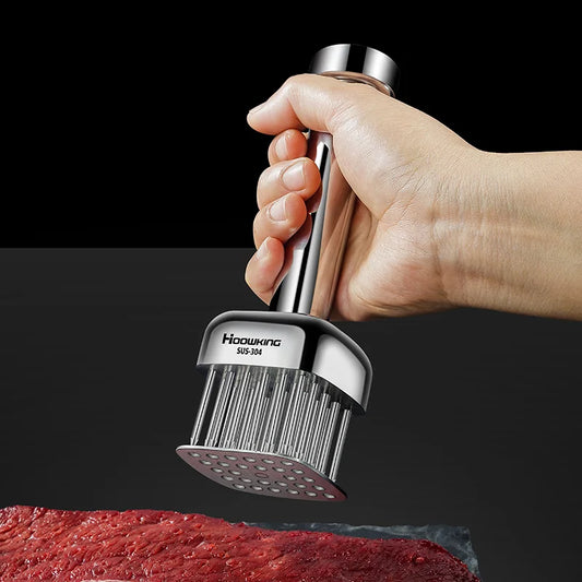 Hand holding a meat tenderizer against a black background
