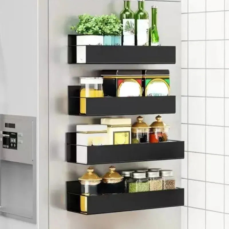 Black wall-mounted shelves with various items against a tiled wall.