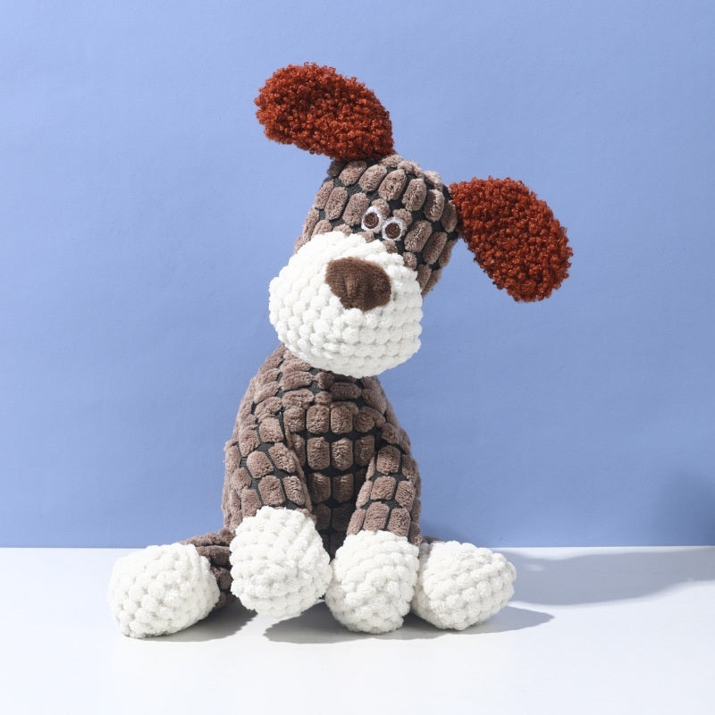 Crocheted dog toy with brown, white, and red colors on a blue background