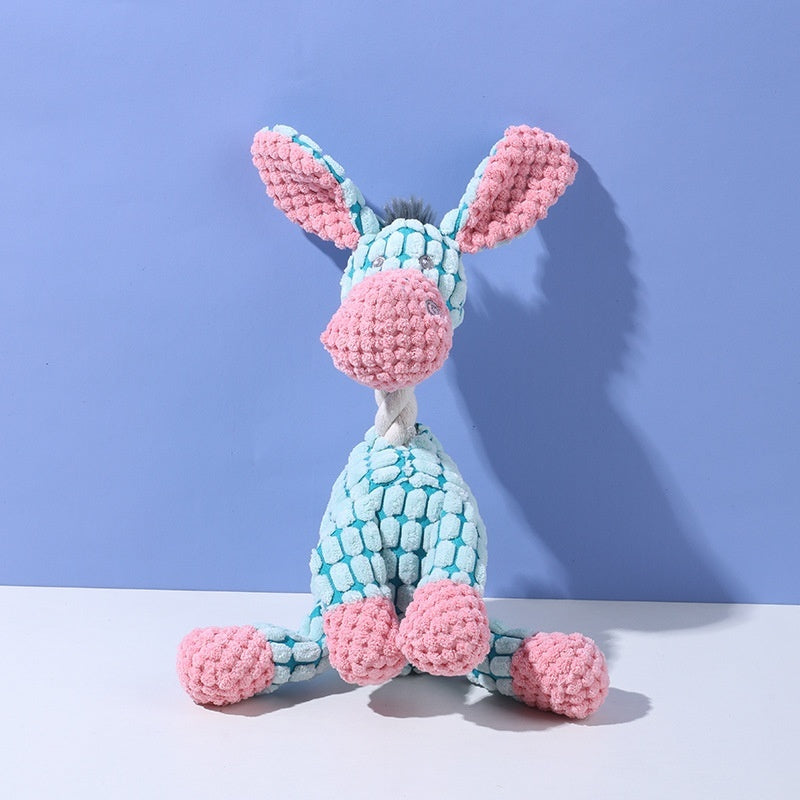Knitted toy resembling a rabbit with pink ears and feet on a blue background