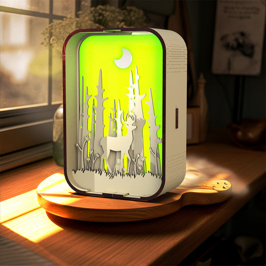 Decorative night light with deer design on a wooden surface