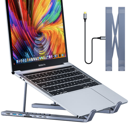 Laptop with a colorful screen on a stand, connected to a power adapter, on a white background