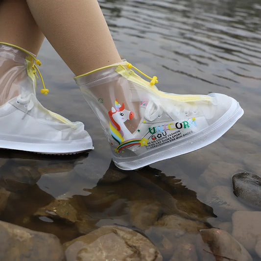 Clear rain boots cover with colorful design worn by a person standing in water.
