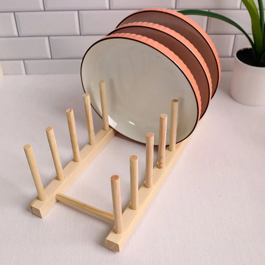 Wooden plate rack with plates on a white surface