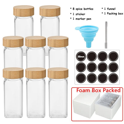 Set of clear spice bottles with wooden lids, funnel, marker pen, and additional components on a white background.